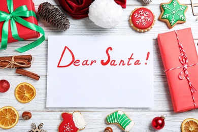 Photo of Letter with title Dear Santa and Christmas decor on white wooden background, flat lay