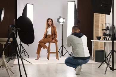 Photo of Beautiful African American model posing for professional photographer in studio