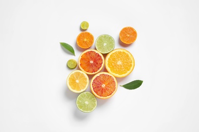 Composition with different citrus fruits on white background, top view