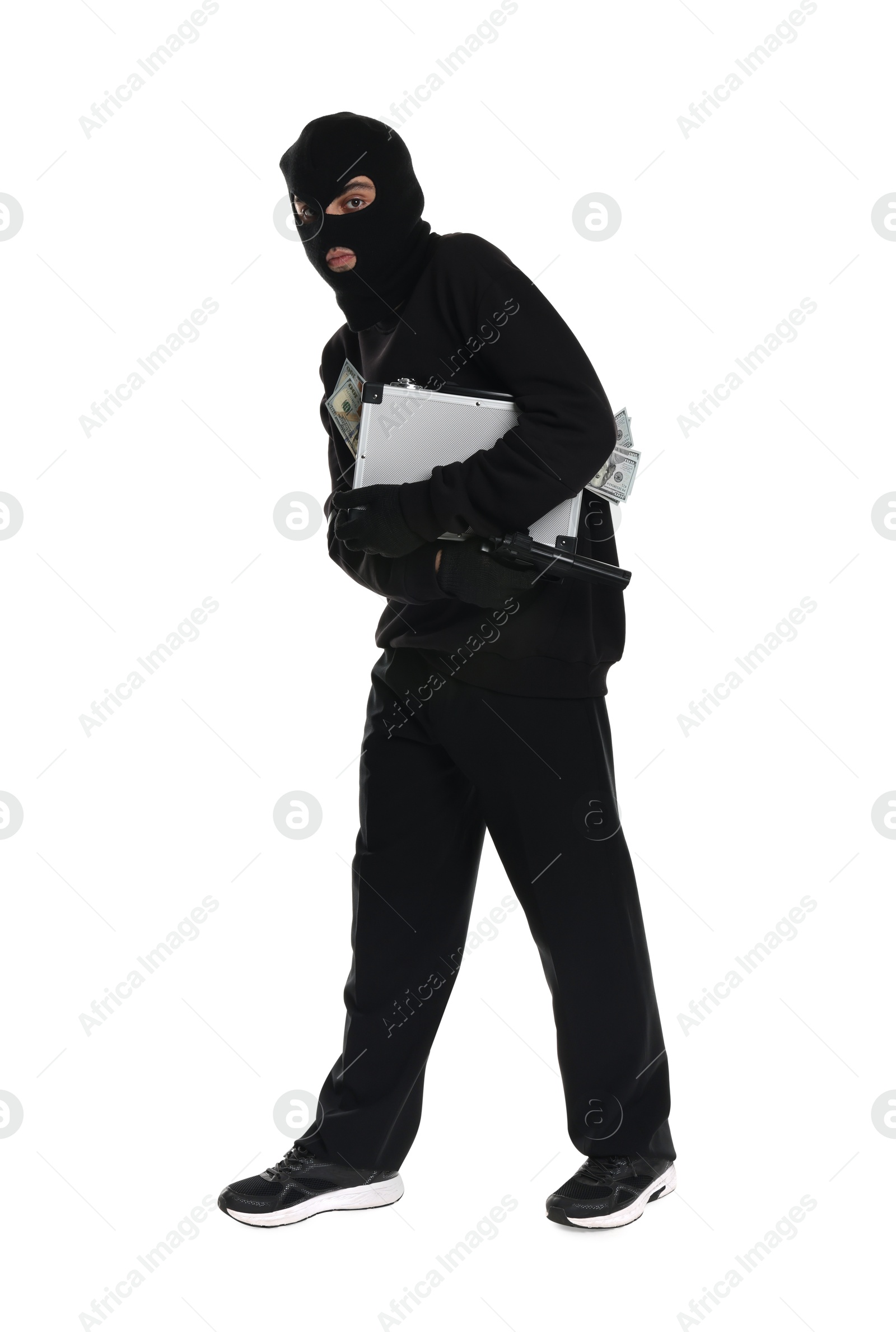 Photo of Thief in balaclava with gun and briefcase of money on white background