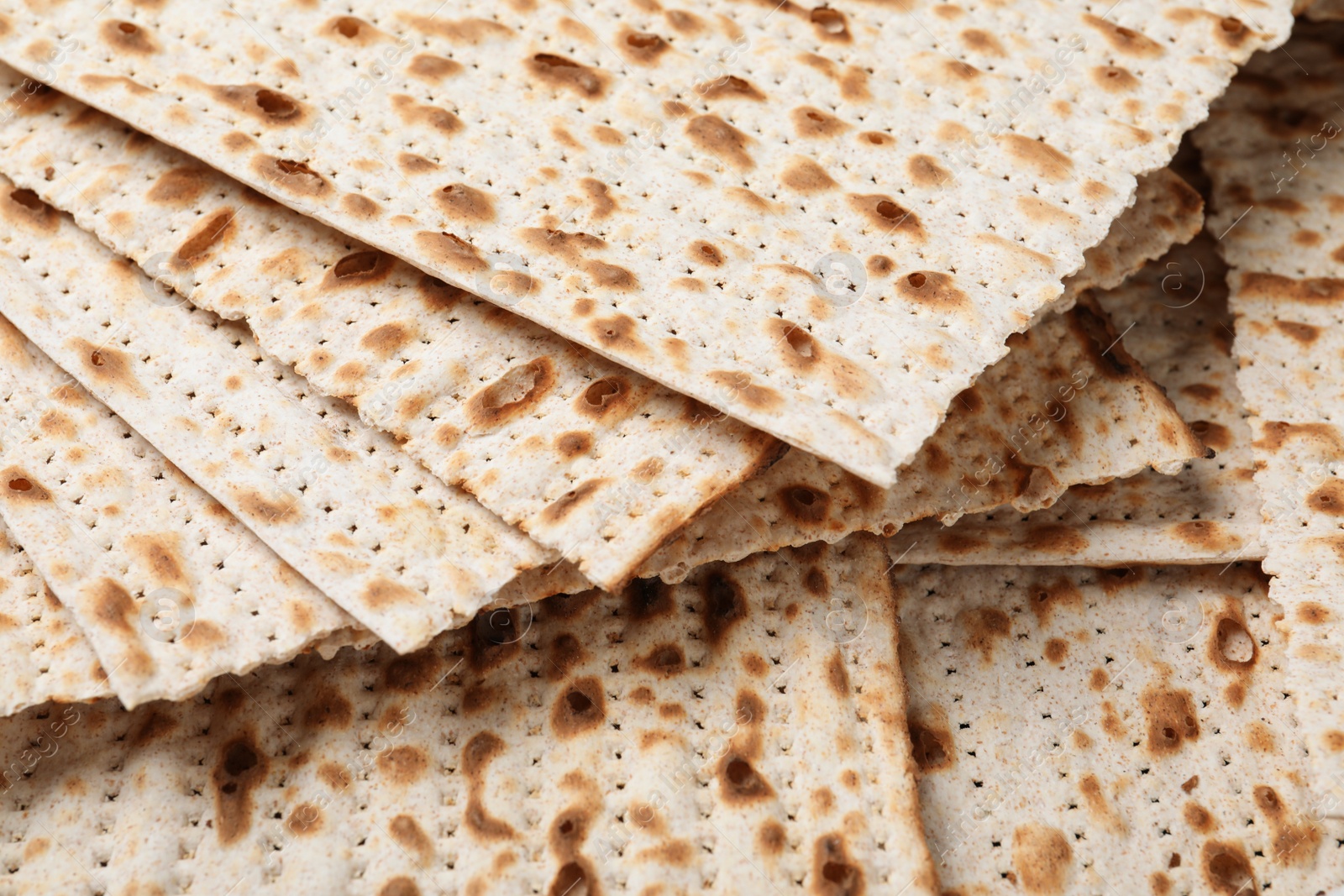 Photo of Traditional matzos as background, closeup. Pesach celebration