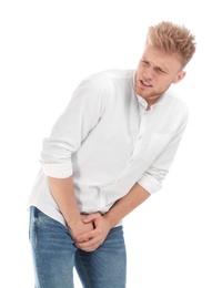 Photo of Young man suffering from pain on white background. Urology problems