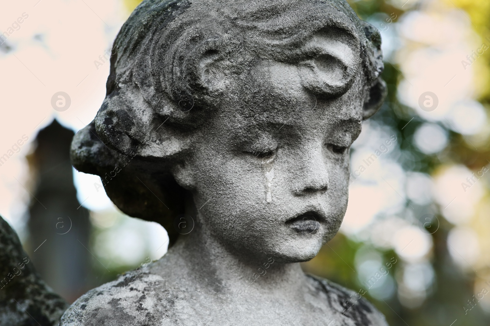 Photo of Beautiful statue of angel at cemetery, closeup. Religious symbol