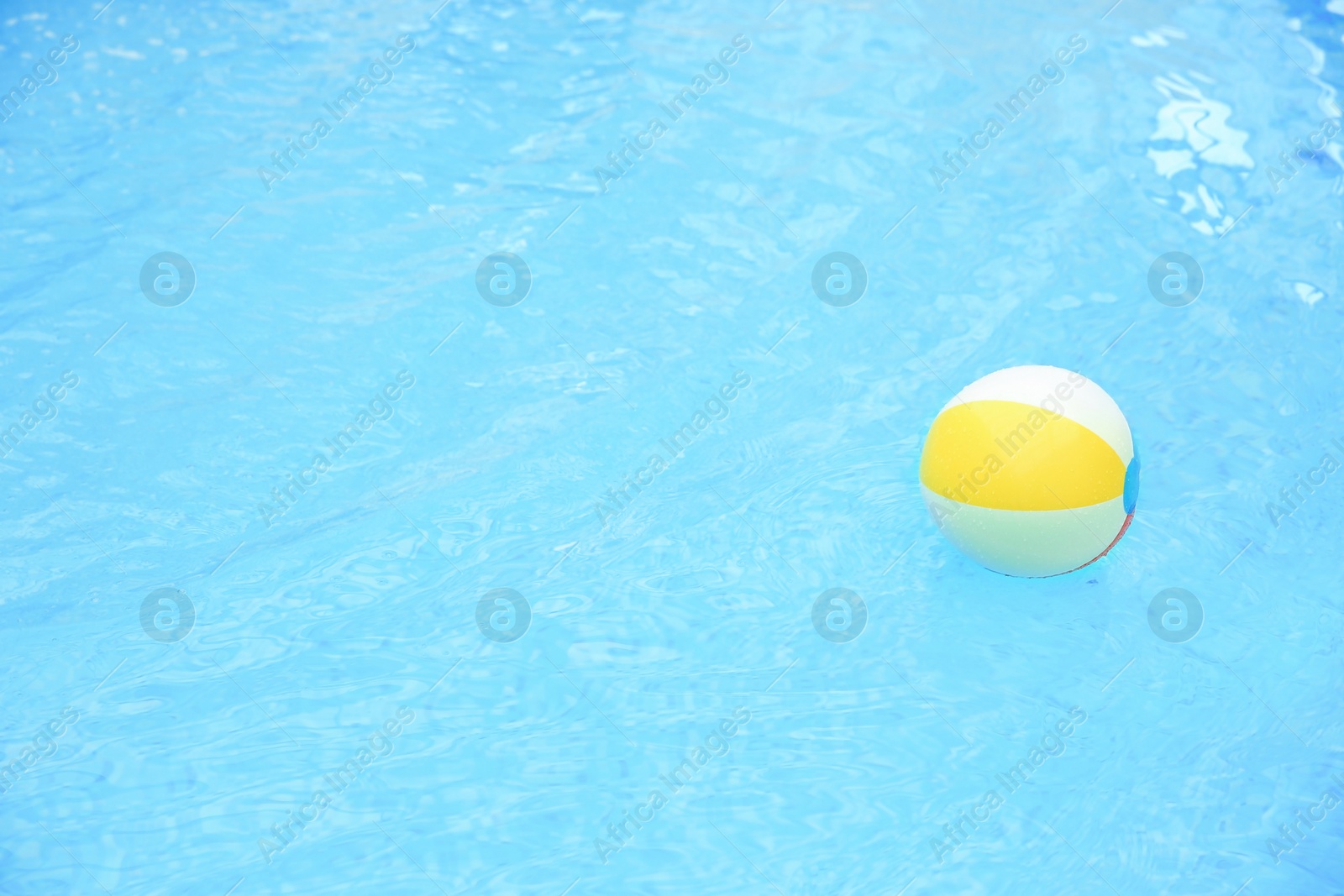 Photo of Colorful inflatable ball floating on water in swimming pool