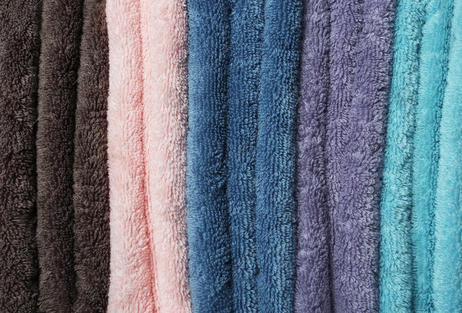 Photo of Different soft terry towels as background, closeup