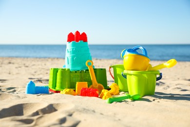 Different child plastic toys on sandy beach