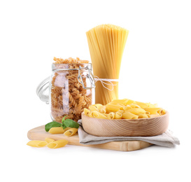 Photo of Different types of pasta and basil  isolated on white