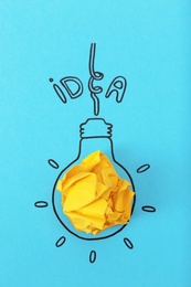 Composition with crumpled paper ball, drawing of lamp bulb and word IDEA on color background. Creative concept