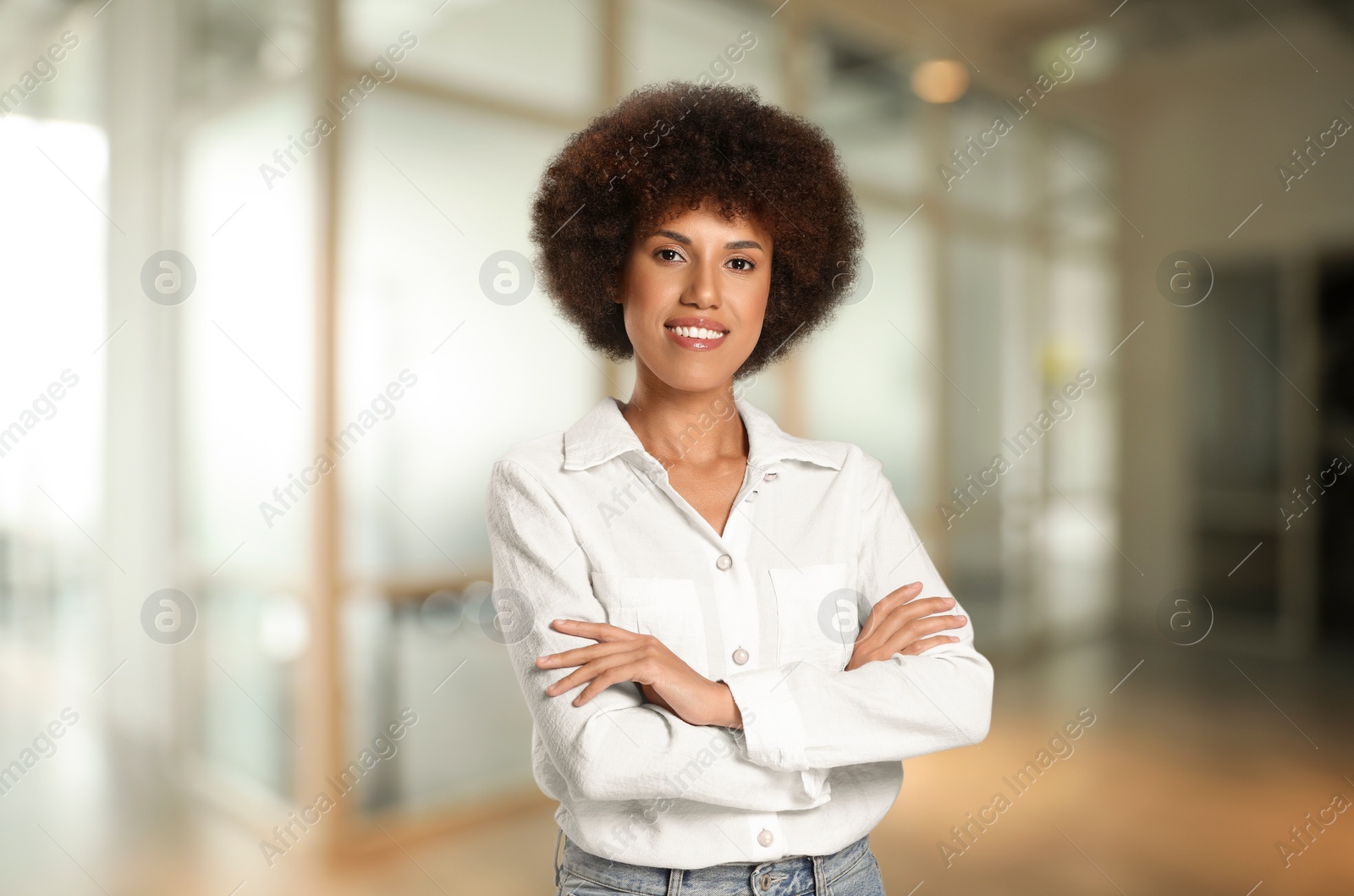 Image of Portrait of happy woman in office. Beautiful girl looking at camera and smiling on blurred background