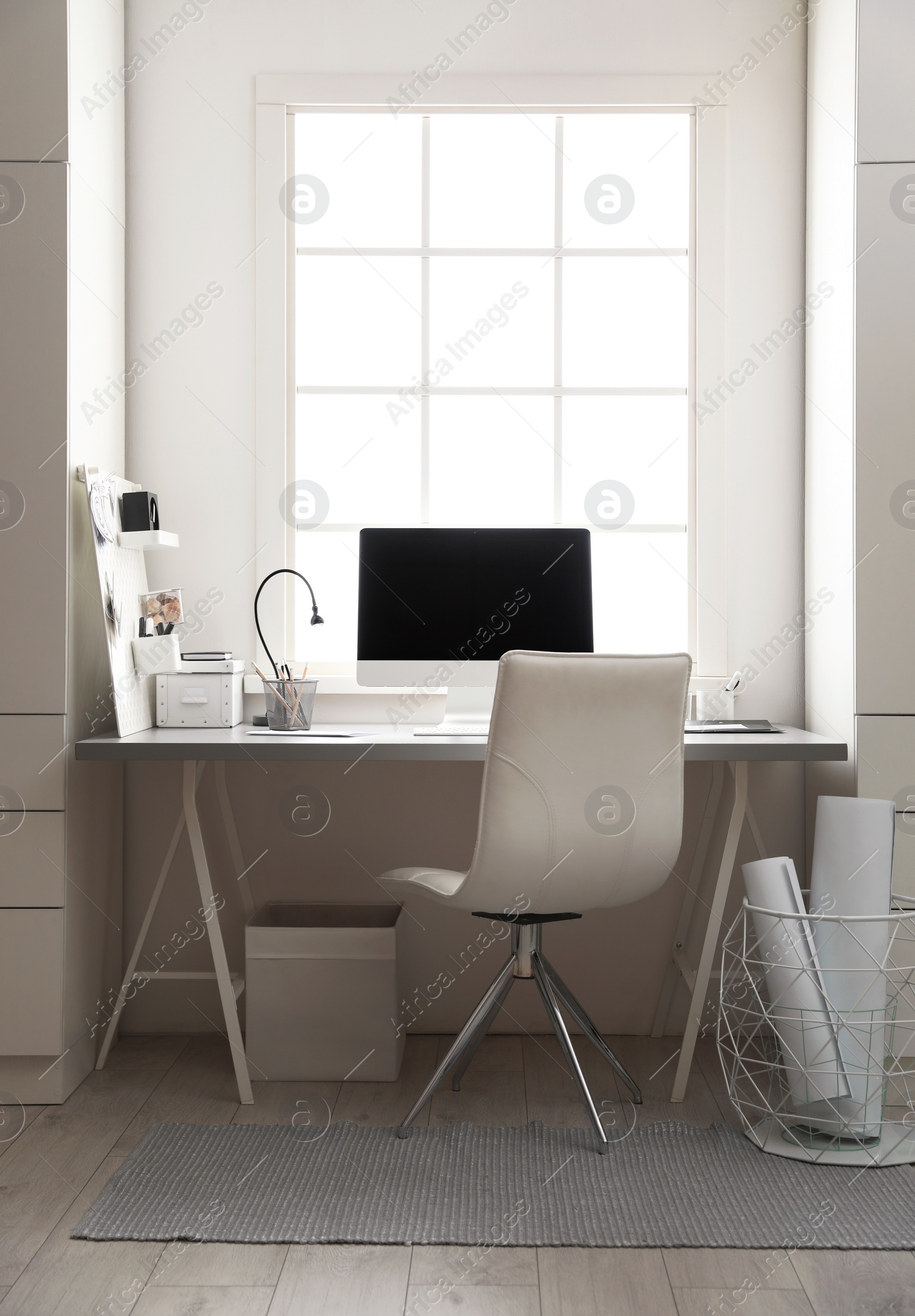 Photo of Light work place with computer near window. Interior design