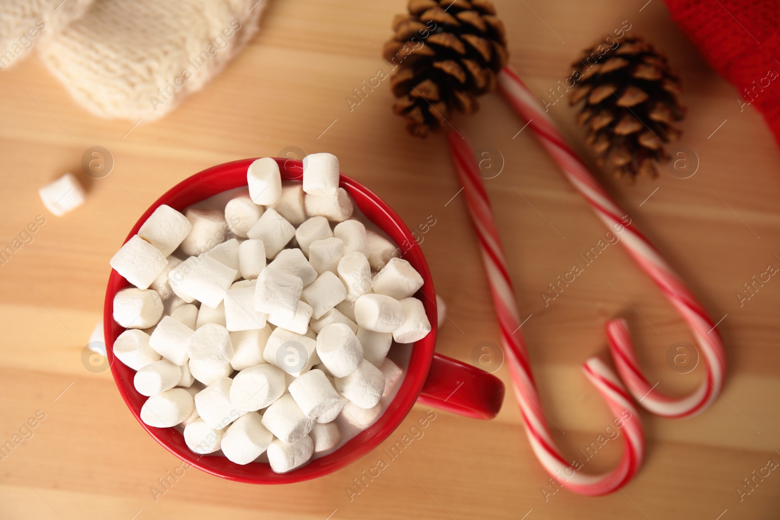 Photo of Cup of hot cocoa with marshmallows on wooden table, top view. Winter drink