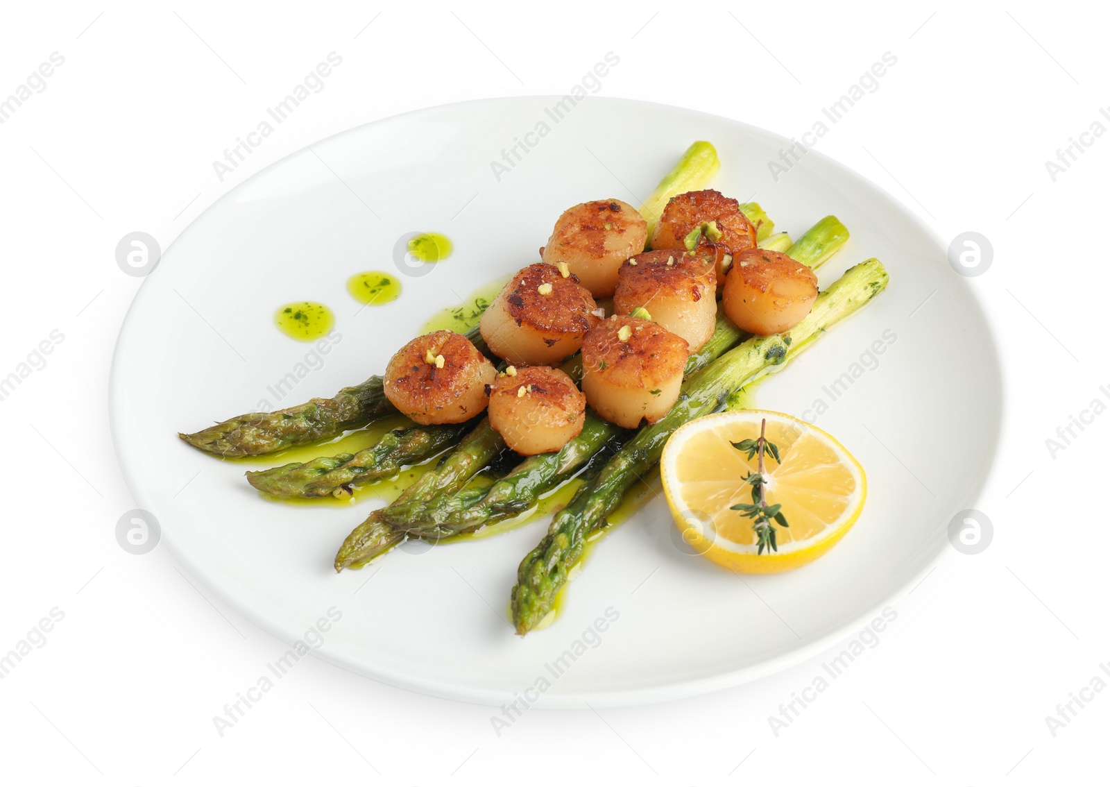 Photo of Delicious fried scallops with asparagus, lemon and thyme isolated on white