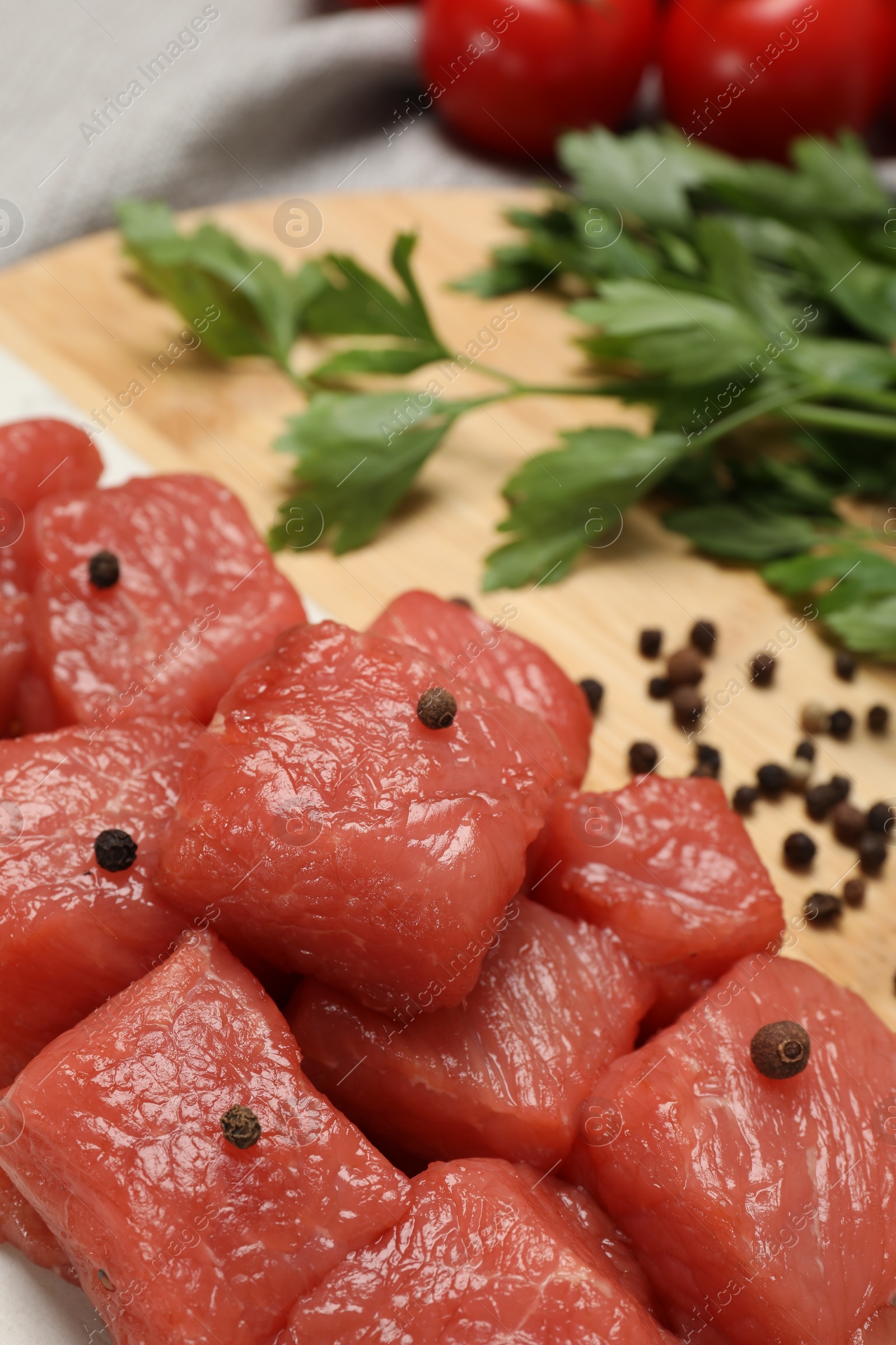 Photo of Cooking delicious goulash. Raw beef meat with spices on board, closeup