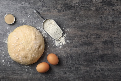 Photo of Flat lay composition with raw dough and products on grey background