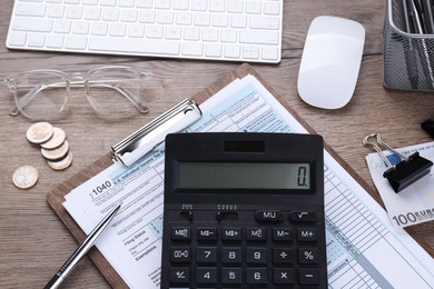 Photo of Tax accounting. Flat lay composition with calculator and document on wooden table