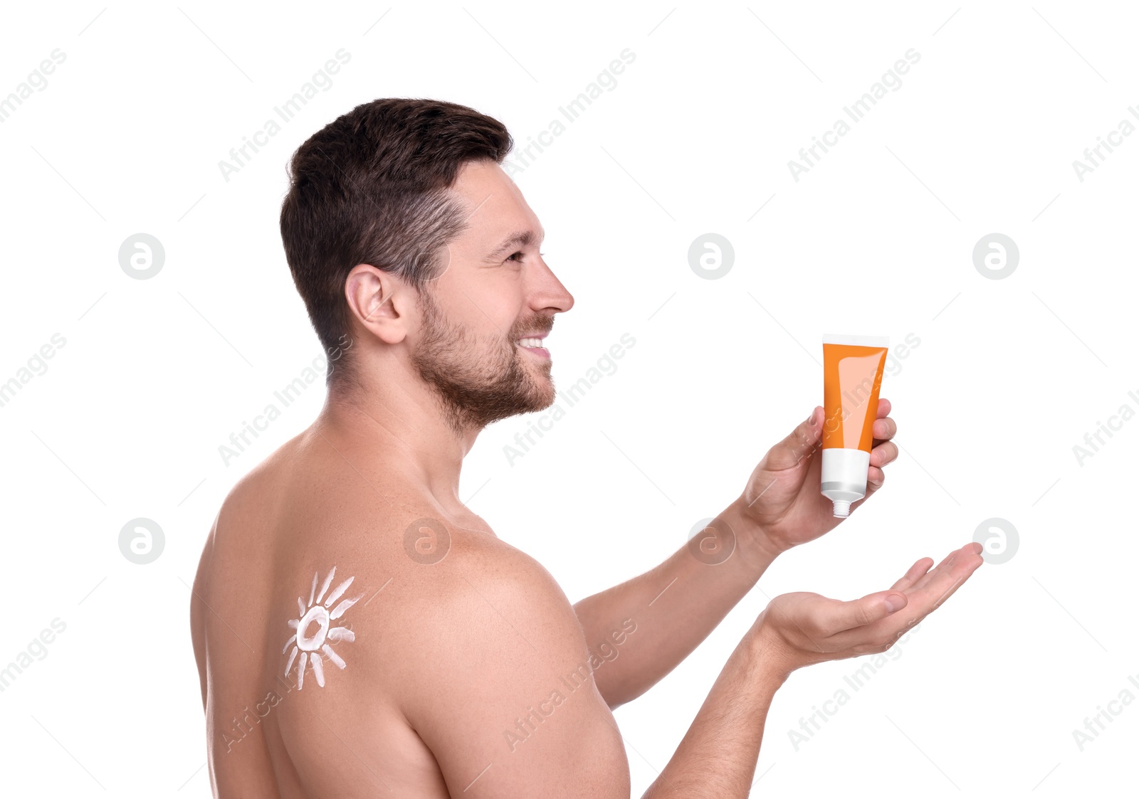 Photo of Handsome man with tube of sun protection cream on white background