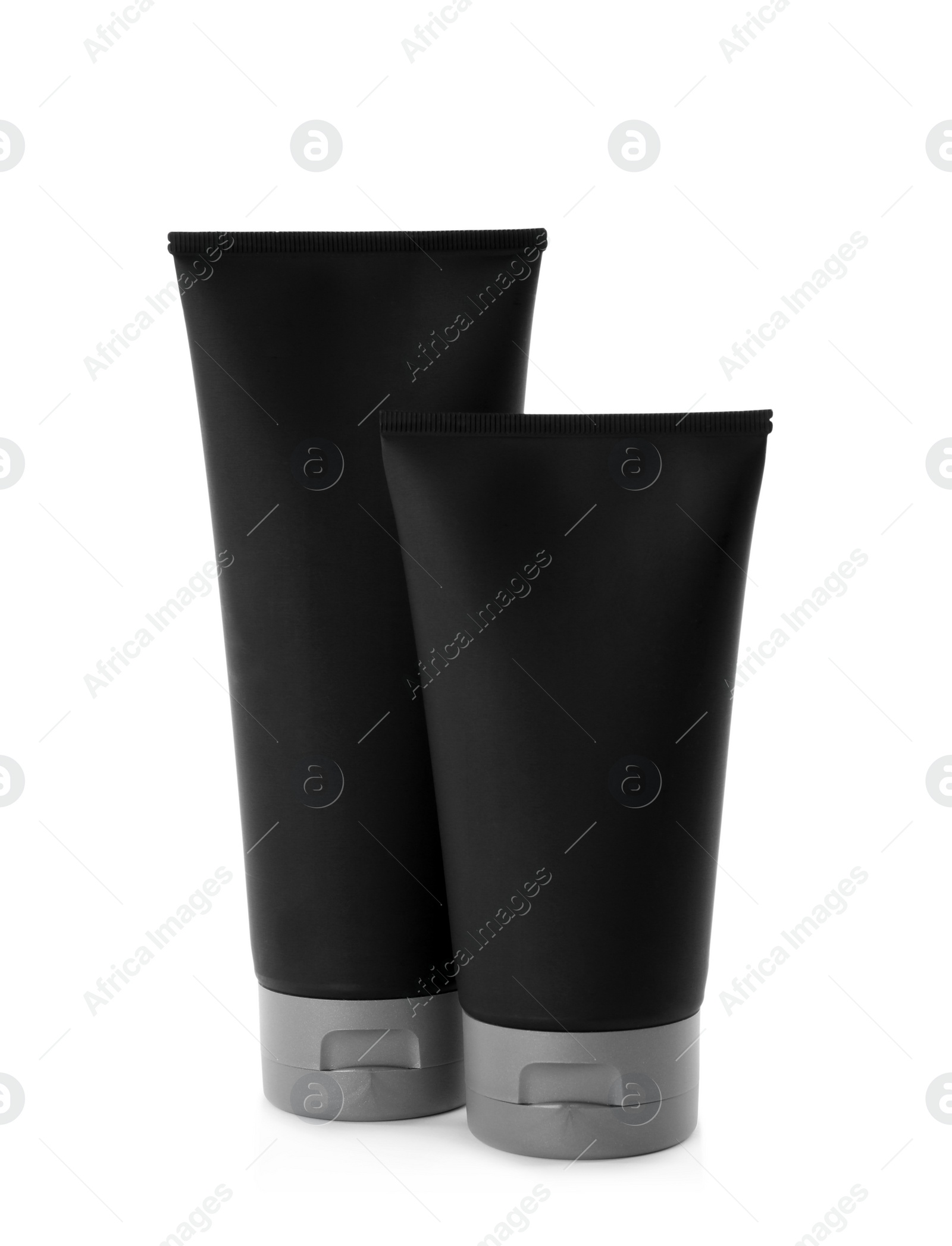 Photo of Black tubes with men's cosmetic products on white background