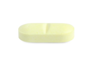 Photo of One yellow pill isolated on white. Medicinal treatment