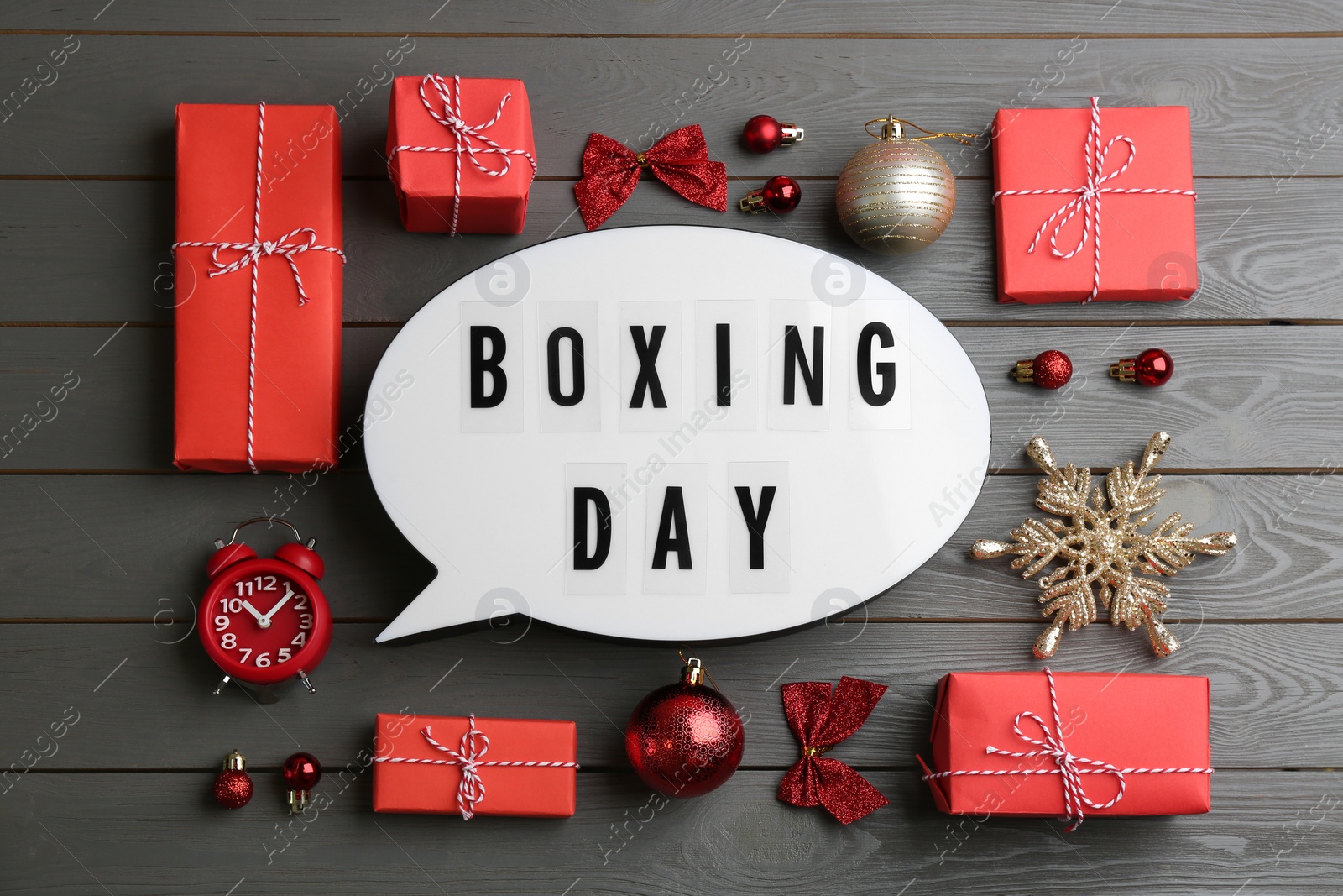 Photo of Flat lay composition with Boxing Day sign and Christmas gifts on grey wooden table