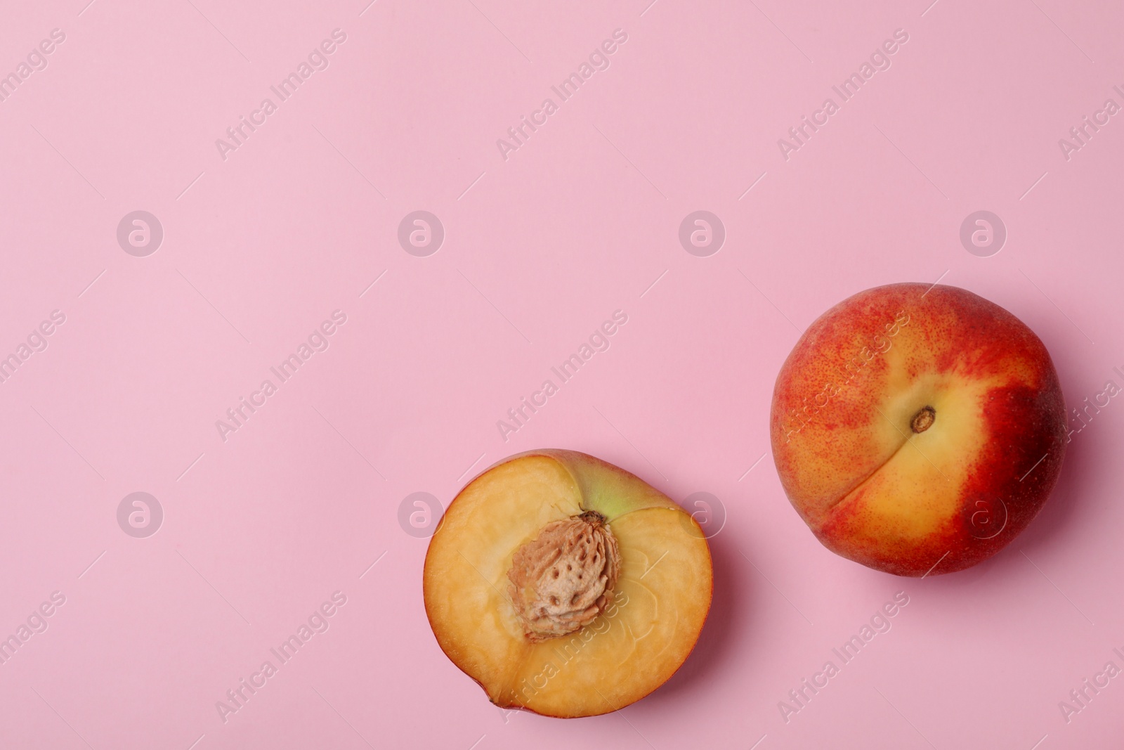 Photo of Sweet juicy peaches on pink background, top view. Space for text