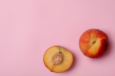 Sweet juicy peaches on pink background, top view. Space for text