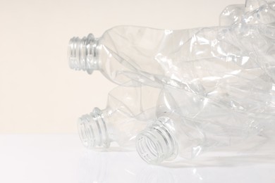 Photo of Crumpled disposable plastic bottles on white background