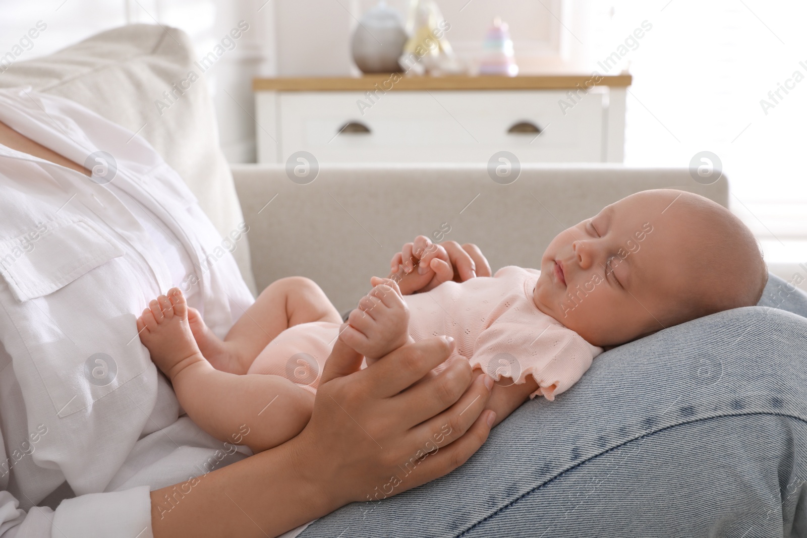 Photo of Mother with her cute sleeping baby at home, closeup