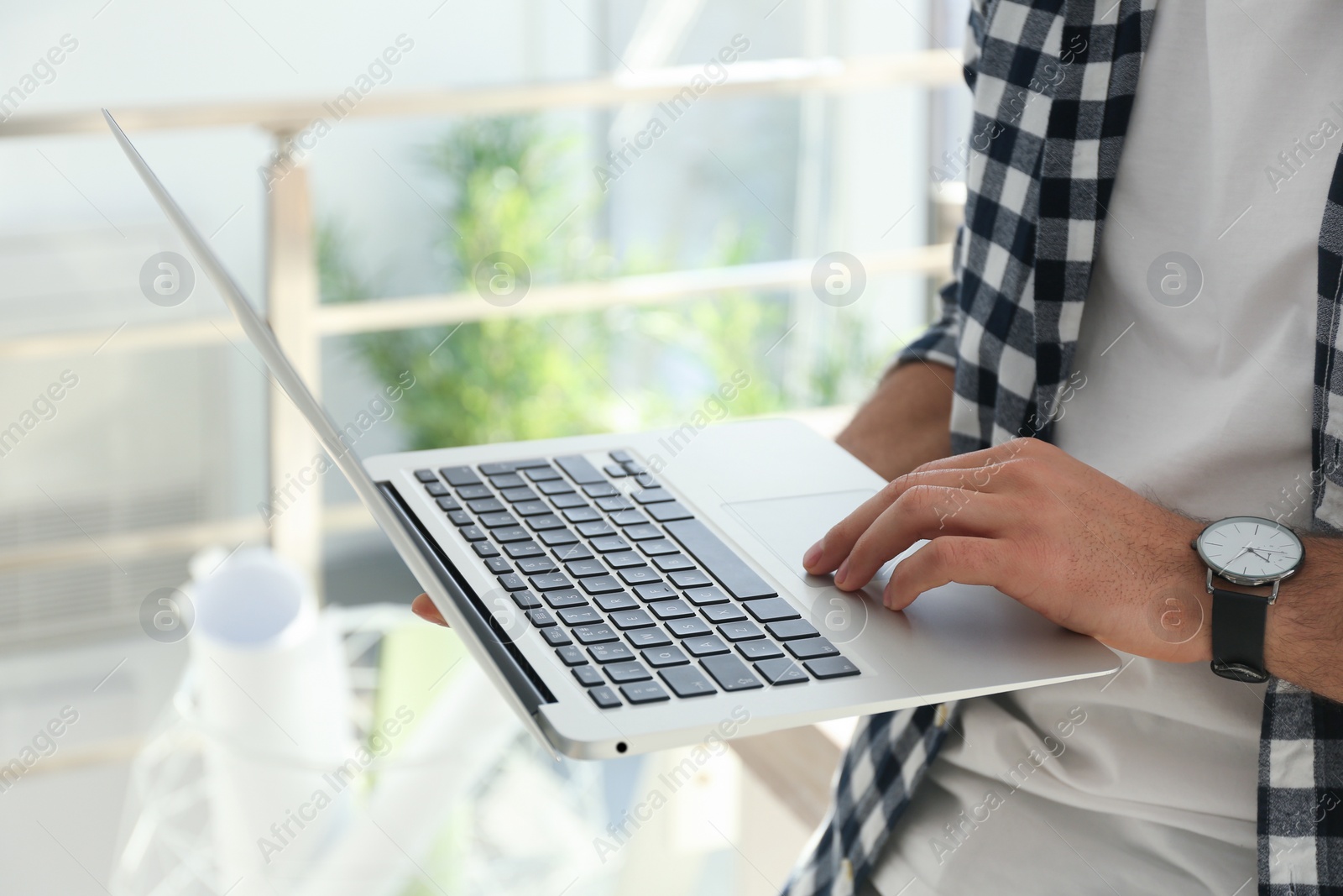 Photo of Freelancer working on laptop in home office, closeup