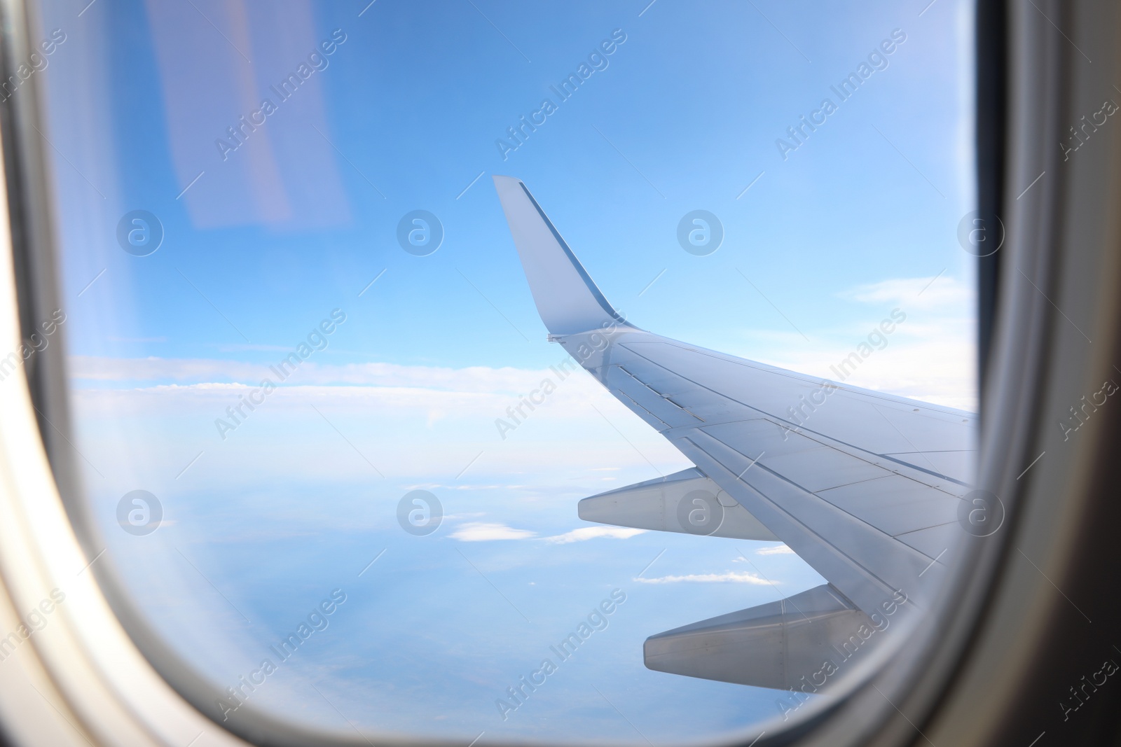 Image of Beautiful view through plane window during flight. Air travel