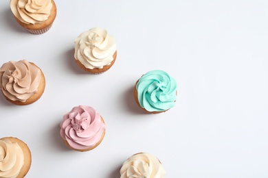 Photo of Flat lay composition with delicious birthday cupcakes and space for text on white background