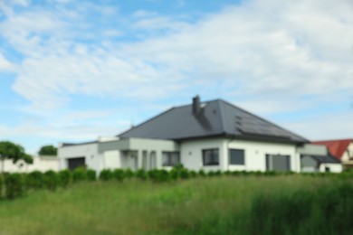 Blurred view of beautiful house under blue sky
