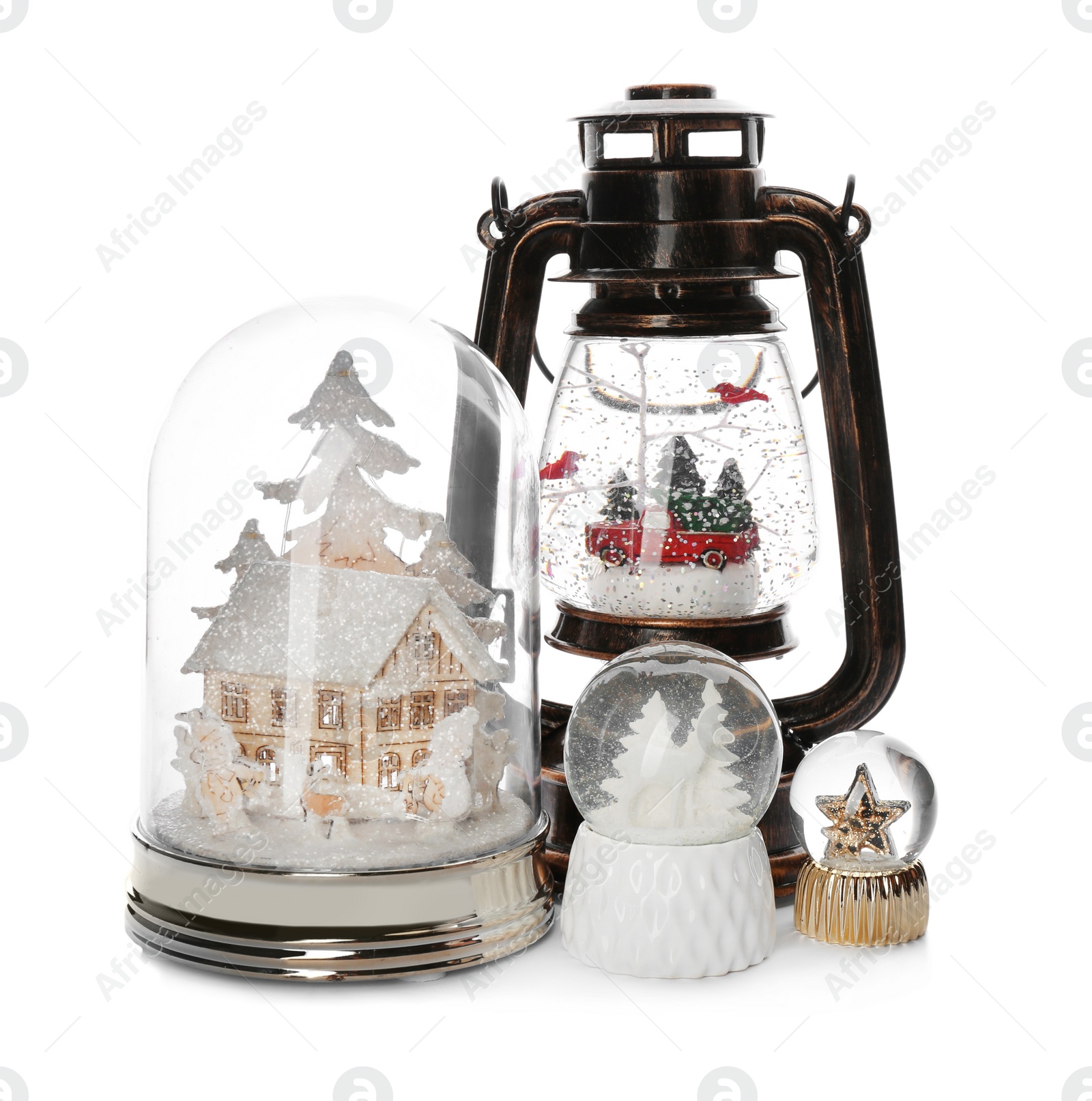 Photo of Different festive snow globes on white background