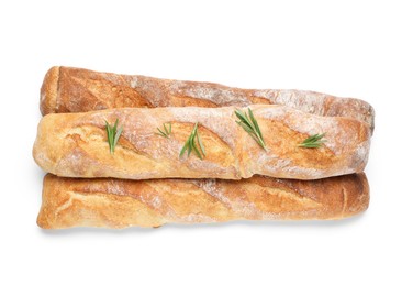 Crispy French baguettes with rosemary on white background, top view. Fresh bread