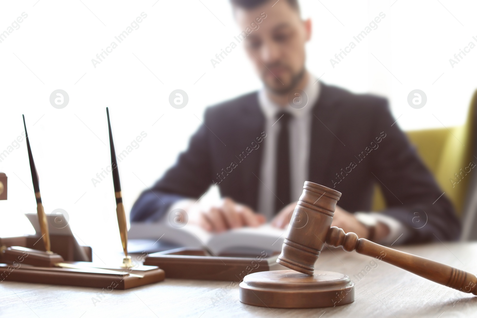 Photo of Gavel on table and lawyer in office