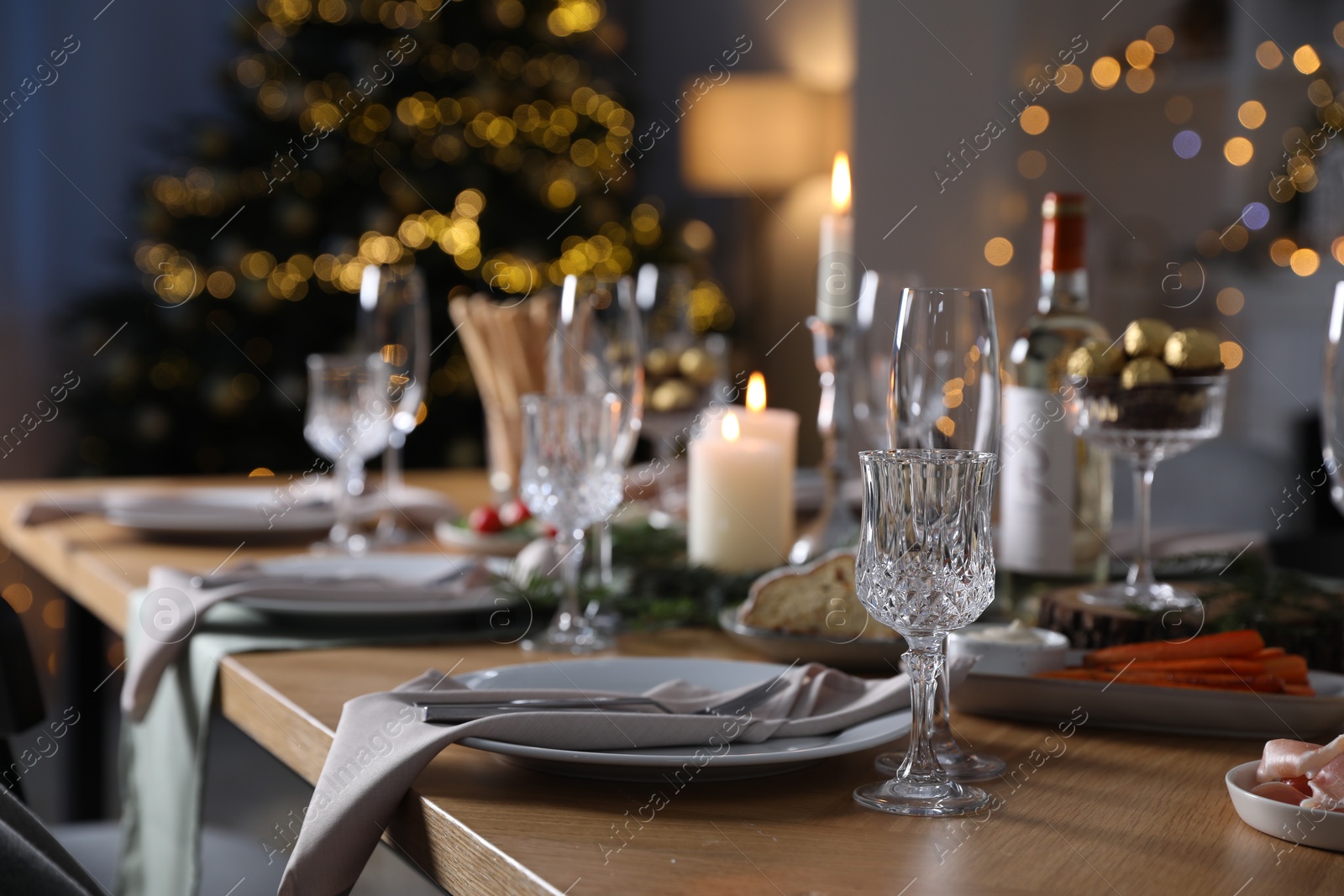 Photo of Christmas table setting with festive decor and dishware indoors