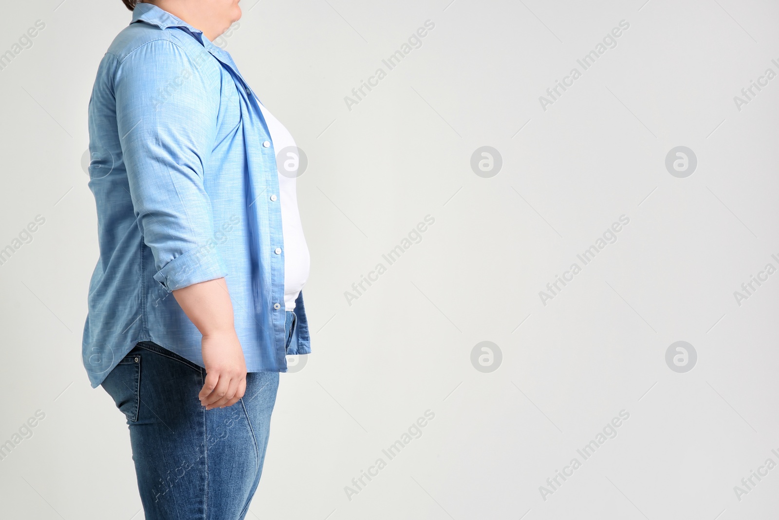 Photo of Overweight woman on light background