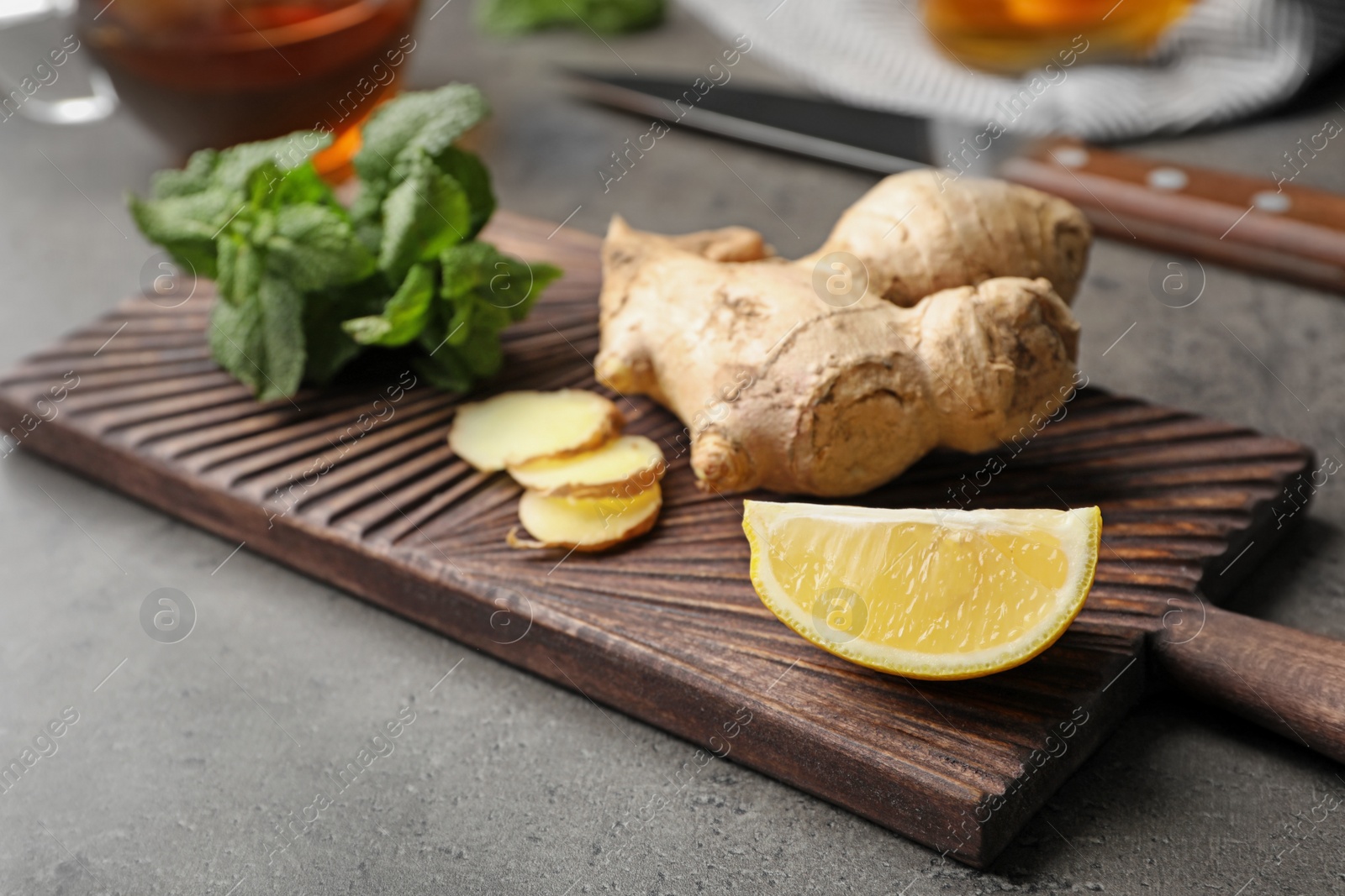 Photo of Wooden board with natural cough remedies on table