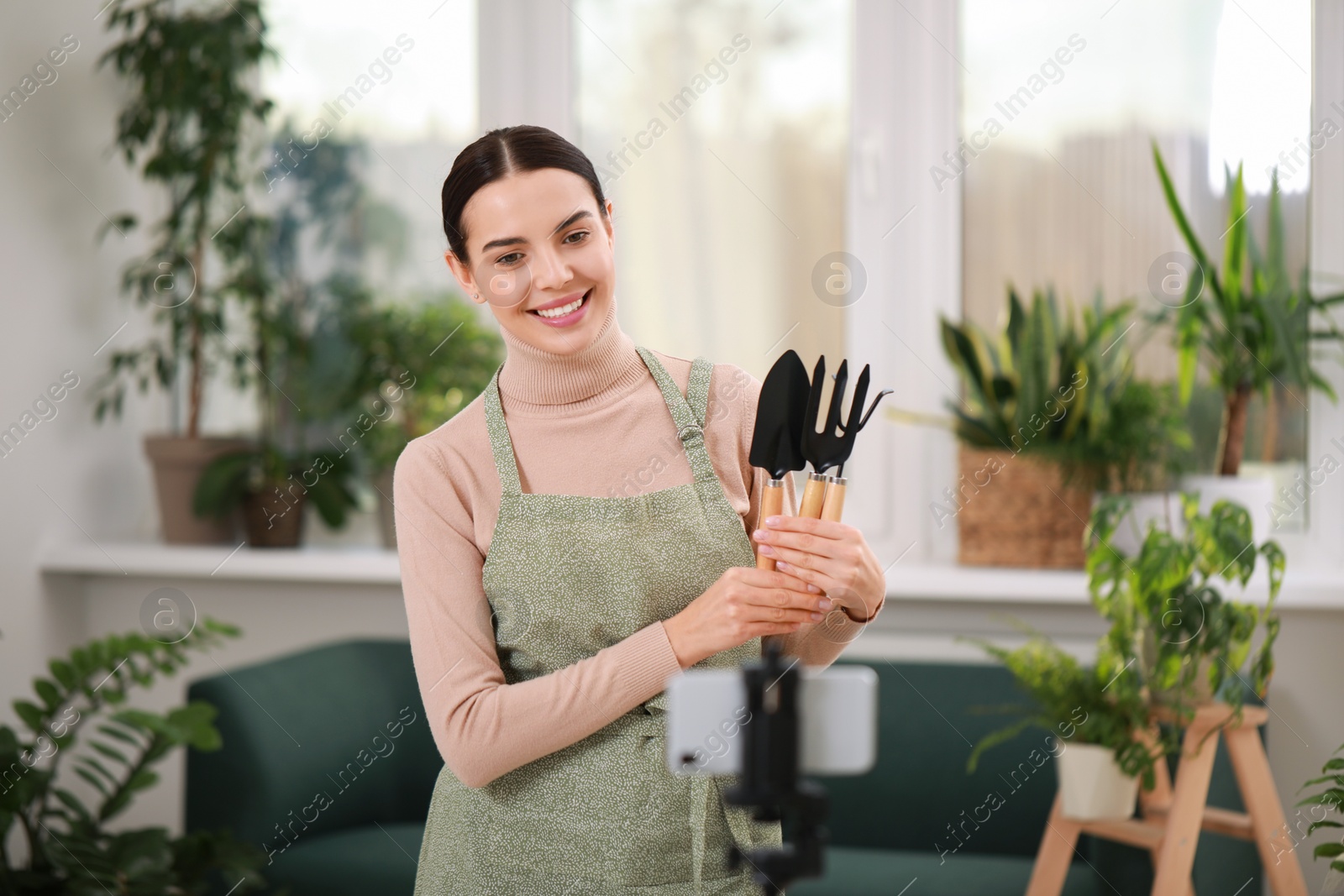 Photo of Teacher conducting online gardening course at home. Time for hobby