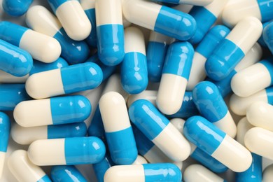 Many antibiotic pills as background, top view