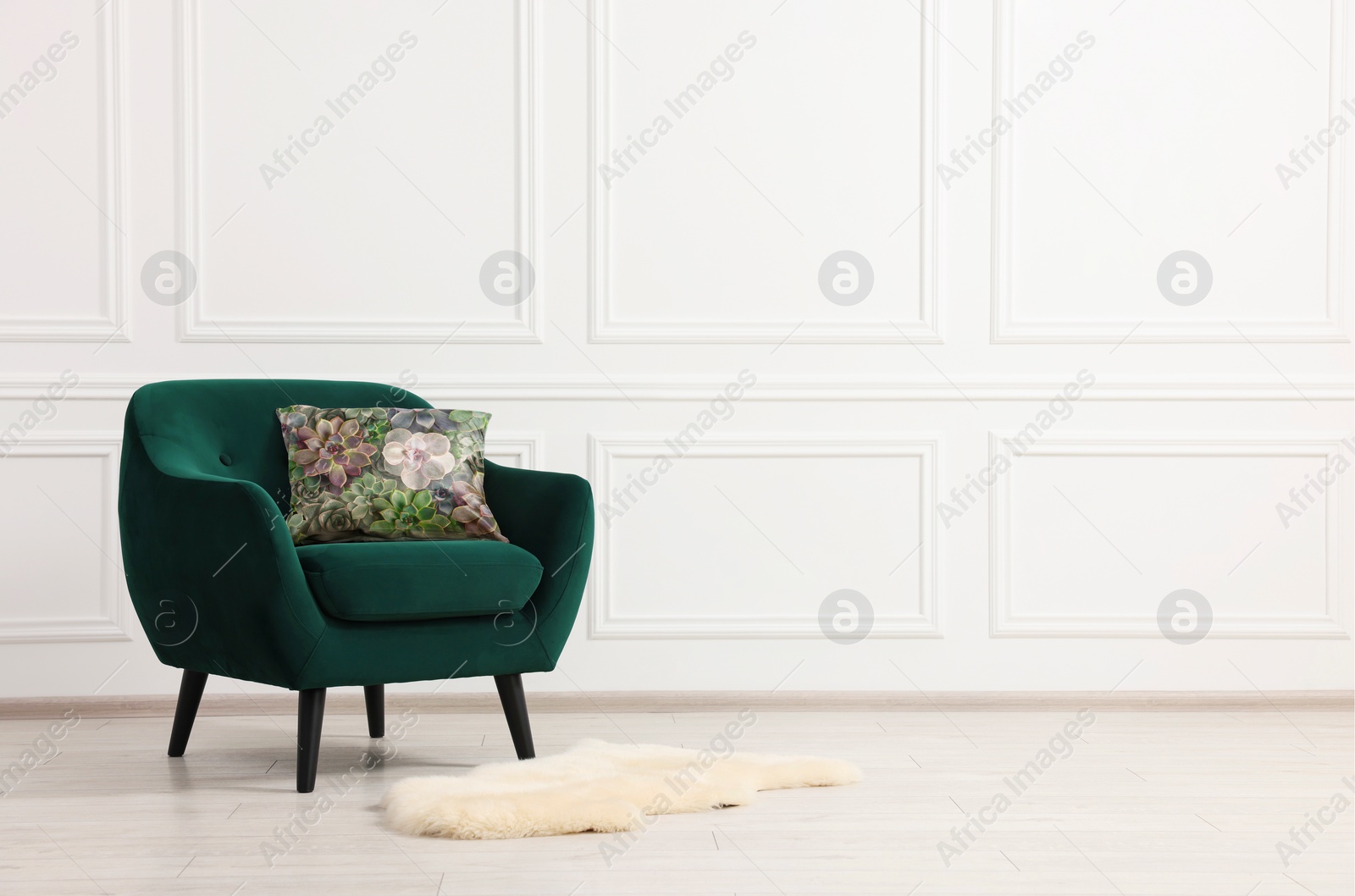 Image of Soft pillow with printed flowers on armchair indoors, space for text
