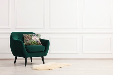 Image of Soft pillow with printed flowers on armchair indoors, space for text