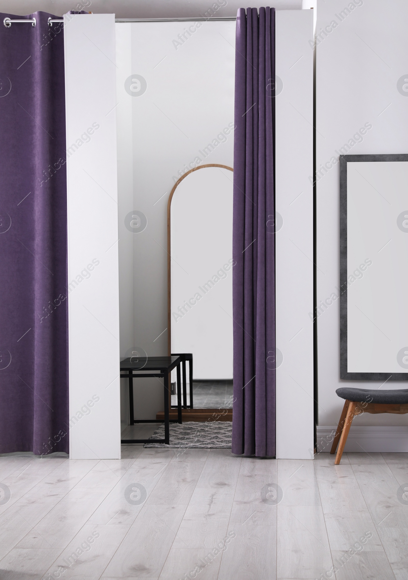 Photo of Empty dressing room in fashion store. Stylish interior