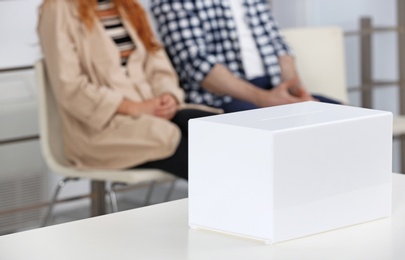 Photo of Ballot box and blurred people on background at polling station