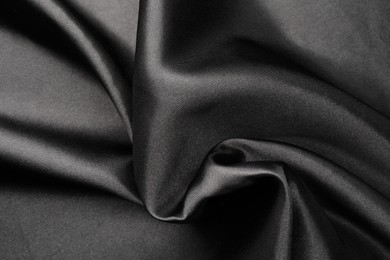 Photo of Crumpled black silk fabric as background, top view