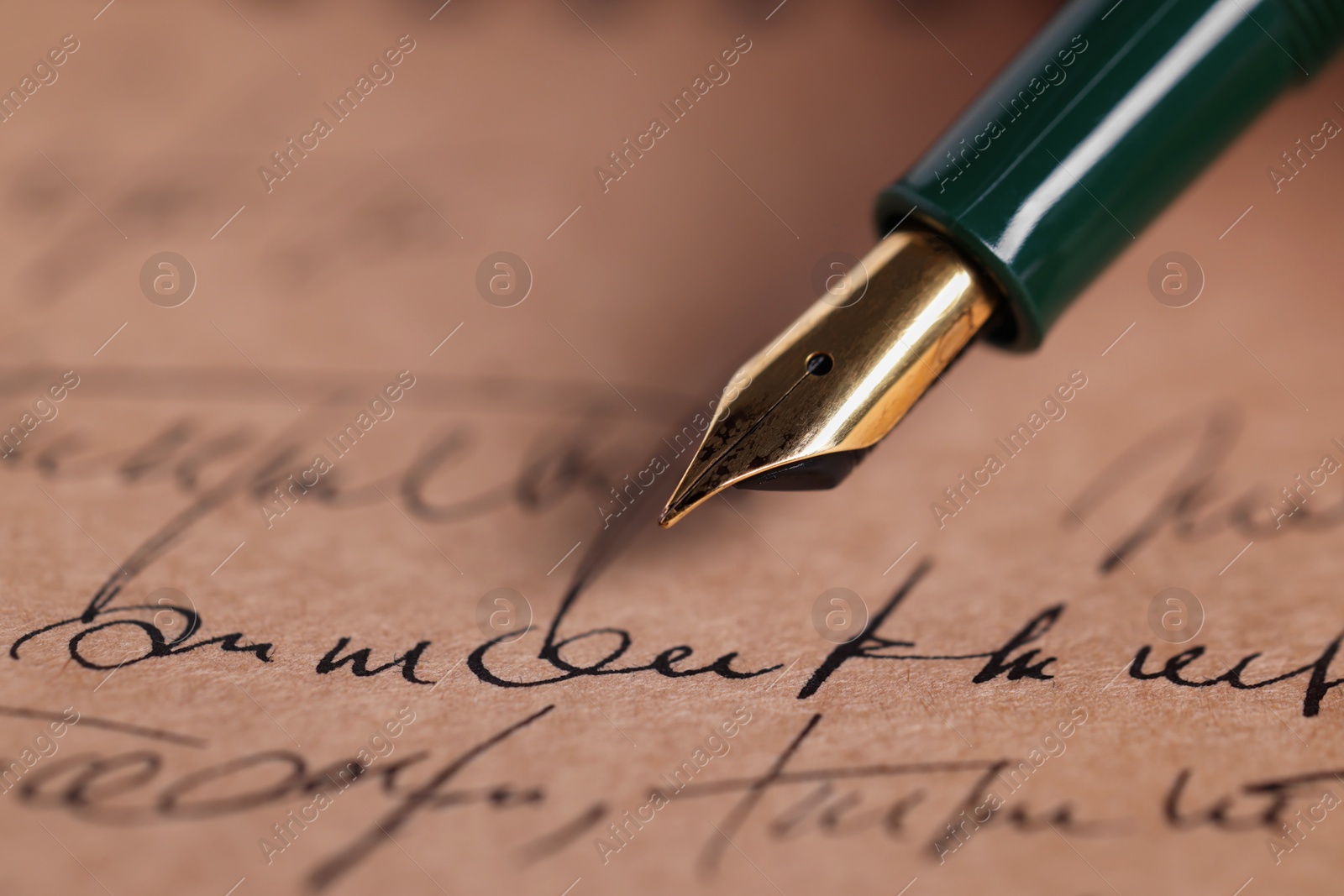 Photo of Elegant fountain pen on handwritten letter, closeup