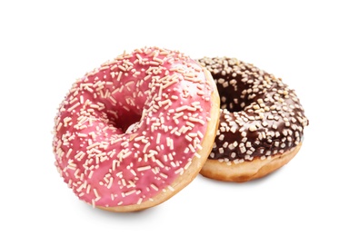 Delicious glazed doughnuts with sprinkles on white background