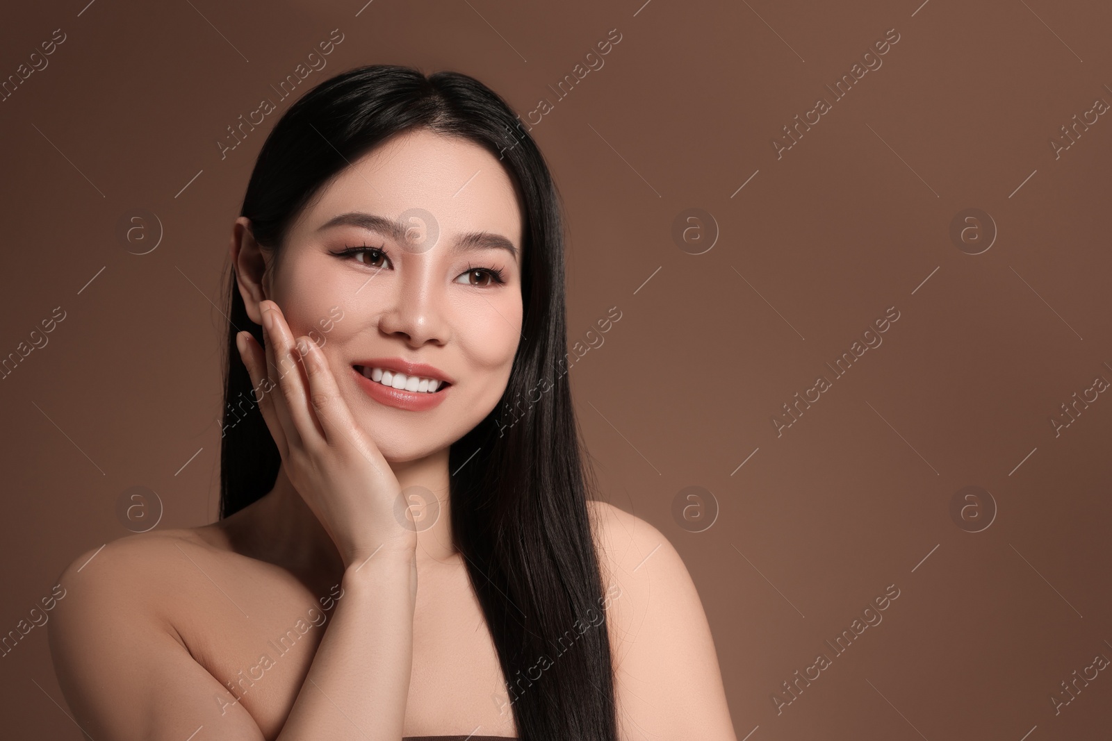 Photo of Portrait of beautiful woman on brown background, space for text