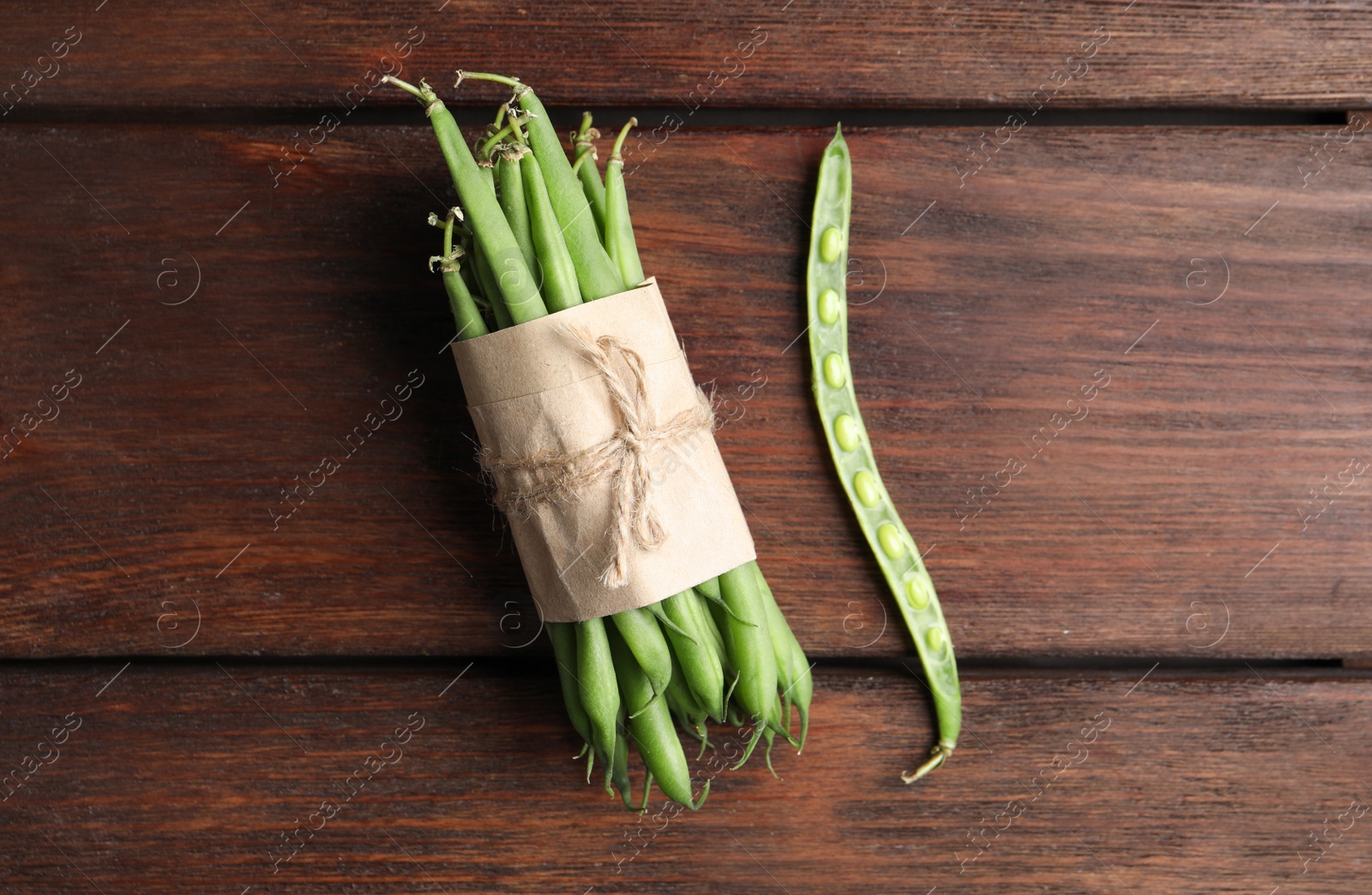 Photo of Fresh green beans on wooden table, flat lay