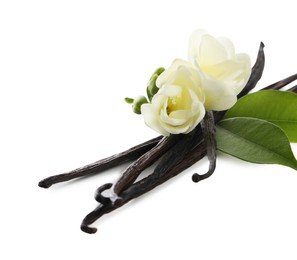 Photo of Vanilla pods, green leaves and flowers isolated on white