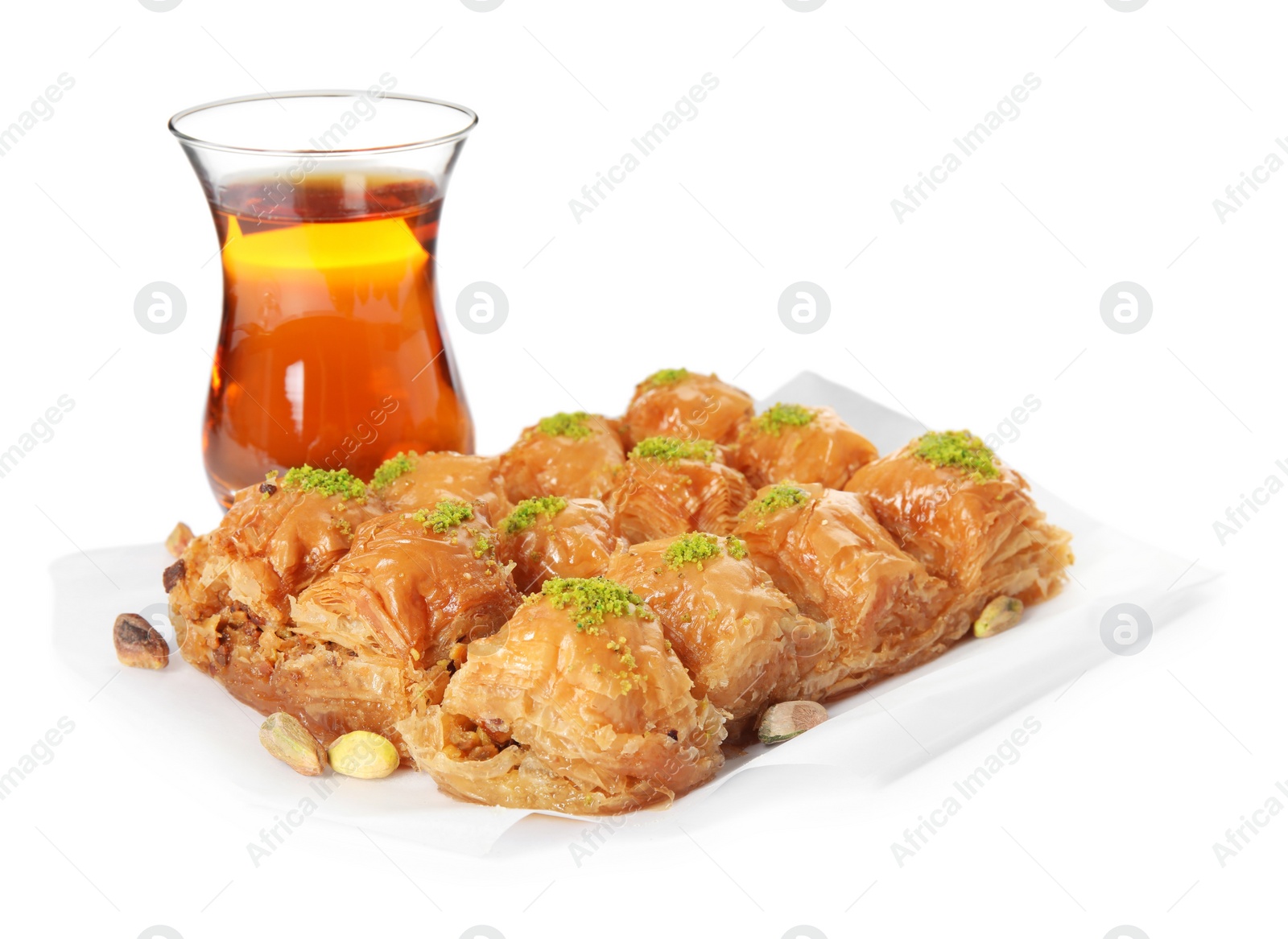 Photo of Delicious sweet baklava with pistachios and hot tea on white background